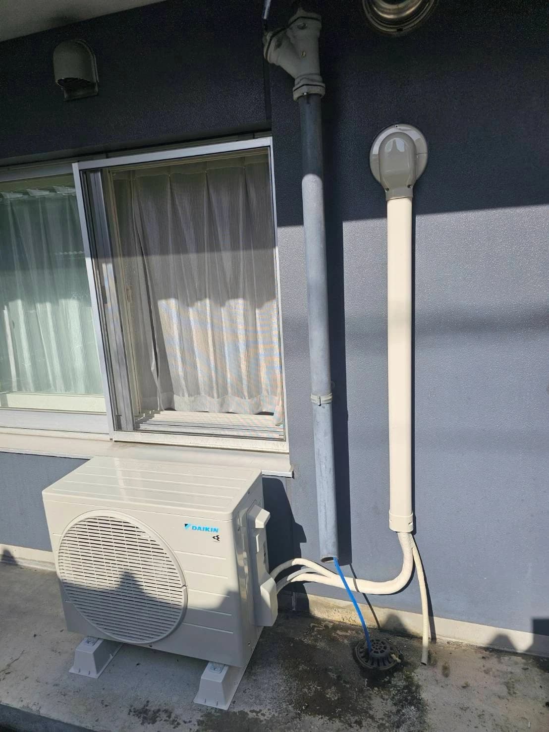 住宅外壁に設置した室外機と、縦に通した配管カバー